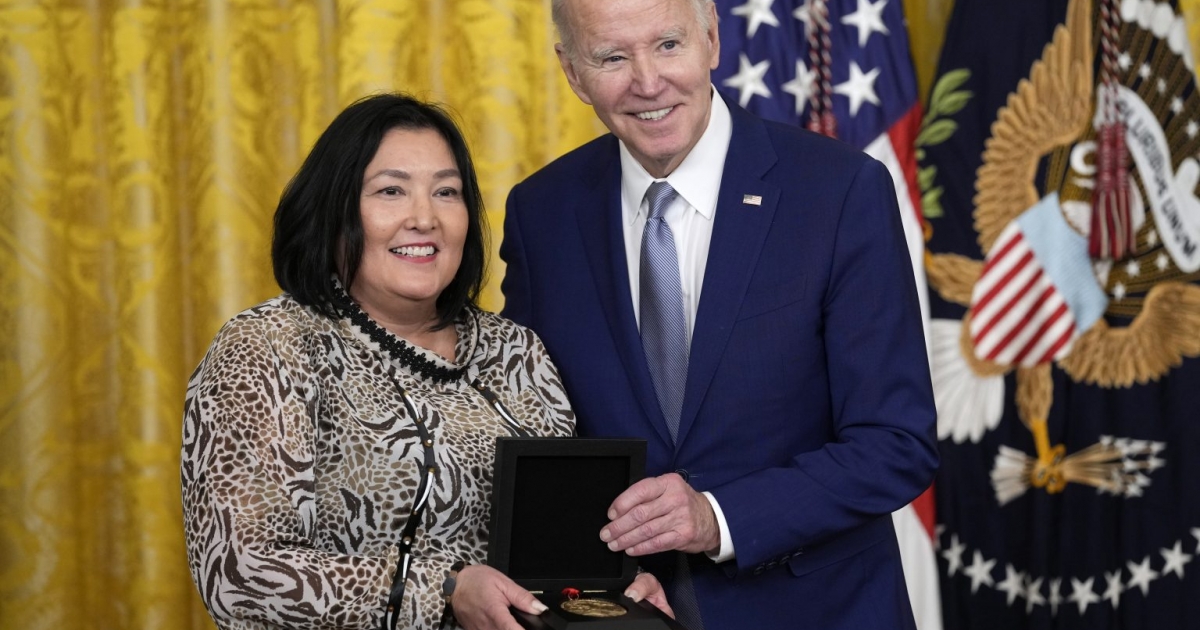 President Joe Biden presenting the National Humanities Medal to Jaclyn Sallee, President and CEO of Koahnic Broadcast Corporation, at the White House.